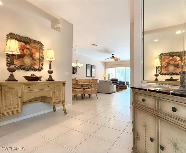 8744 Naples Heritage Dr Unit E28, Naples, FL 34112 - hall featuring light tile patterned flooring and an inviting chandelier