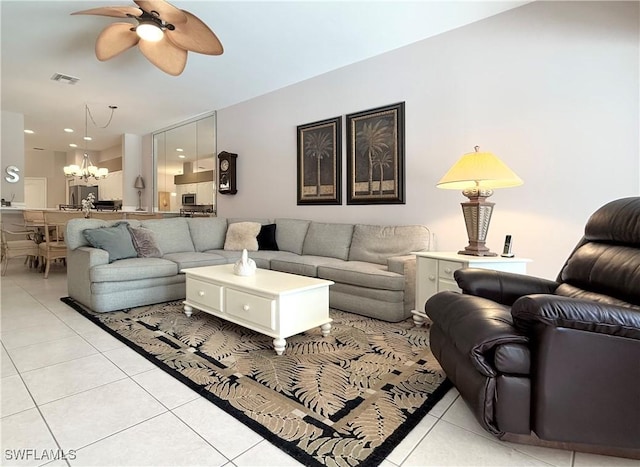 8744 Naples Heritage Dr Unit E28, Naples, FL 34112 - tiled living room featuring ceiling fan with notable chandelier