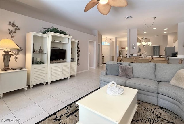 8744 Naples Heritage Dr Unit E28, Naples, FL 34112 - living room featuring ceiling fan with notable chandelier and light tile patterned floors