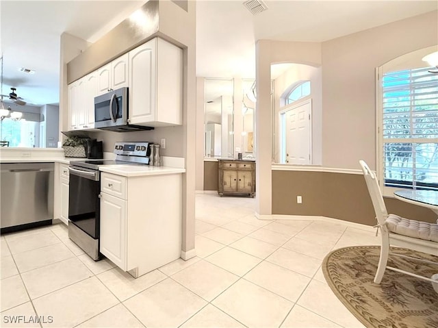 8744 Naples Heritage Dr Unit E28, Naples, FL 34112 - kitchen featuring stainless steel appliances, light tile patterned floors, white cabinets, and ceiling fan