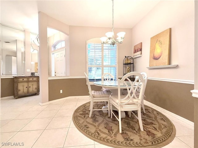 8744 Naples Heritage Dr Unit E28, Naples, FL 34112 - dining room featuring light tile patterned flooring and an inviting chandelier