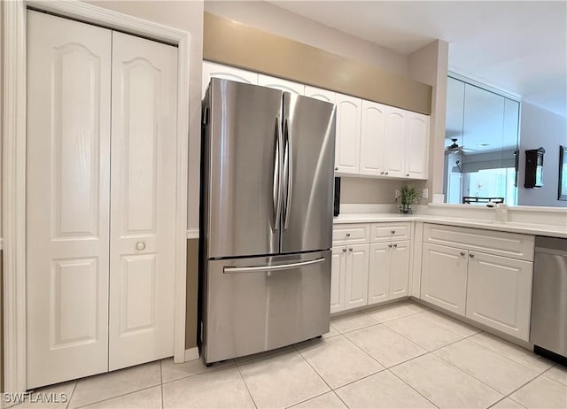 8744 Naples Heritage Dr Unit E28, Naples, FL 34112 - kitchen featuring ceiling fan, appliances with stainless steel finishes, light tile patterned floors, and white cabinets
