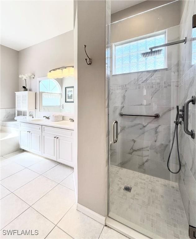 8744 Naples Heritage Dr Unit E28, Naples, FL 34112 - bathroom with vanity, tile patterned floors, and shower with separate bathtub