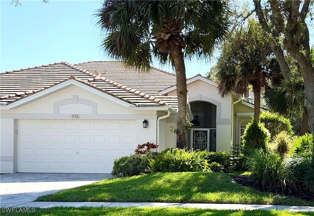 ranch-style house with a garage and a front lawn