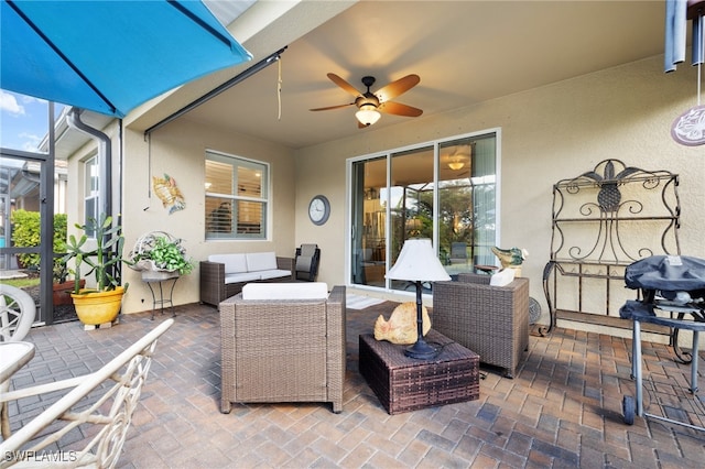 view of patio with a lanai, outdoor lounge area, and a ceiling fan