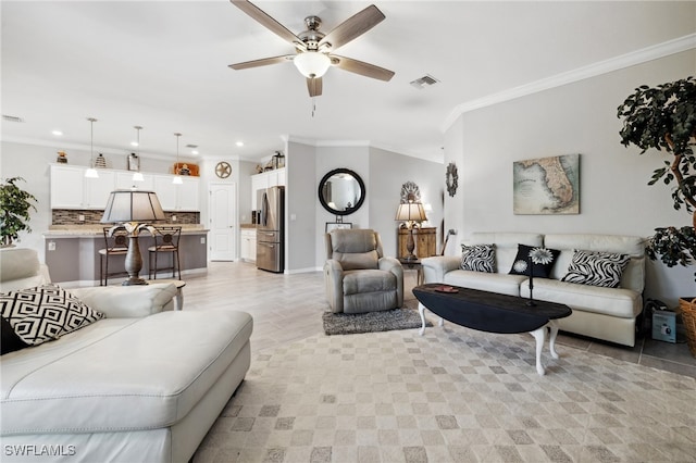 living room with ornamental molding and ceiling fan