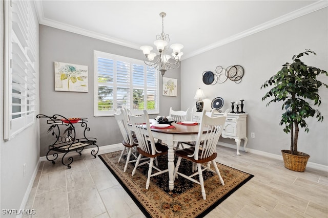 dining room featuring ornamental molding, a notable chandelier, and light hardwood / wood-style flooring