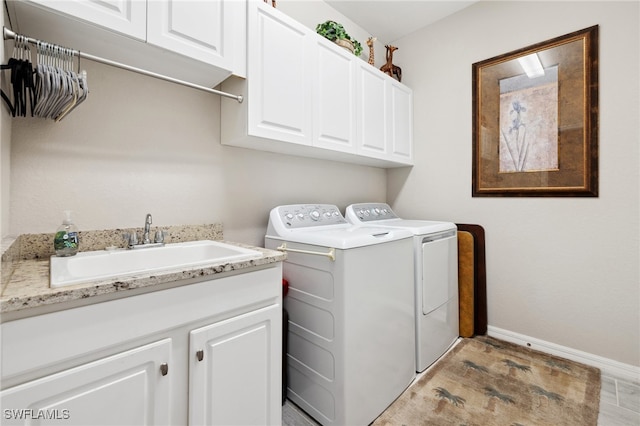 clothes washing area featuring cabinets, separate washer and dryer, and sink