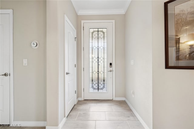 tiled foyer featuring ornamental molding