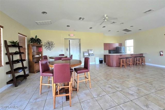 dining room featuring light tile patterned floors and ceiling fan