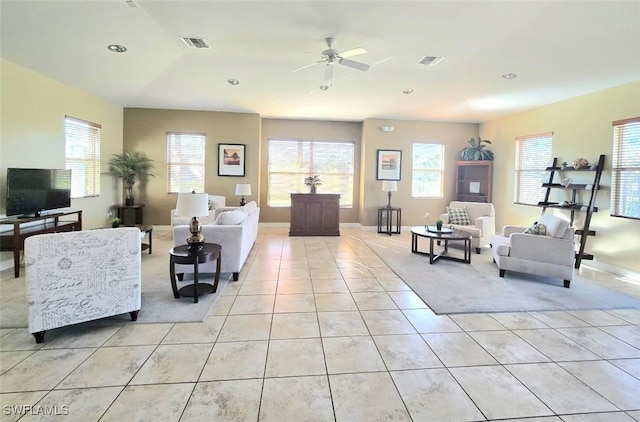 tiled living room with plenty of natural light and ceiling fan