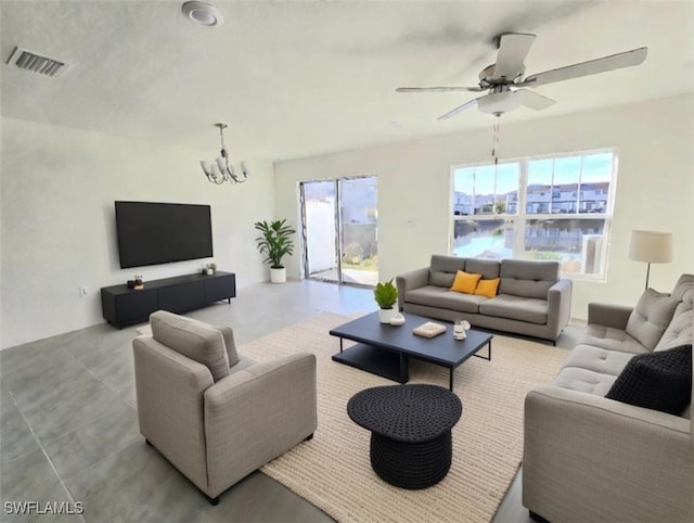 living room featuring ceiling fan with notable chandelier