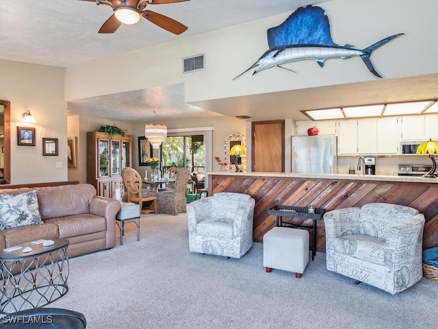 living room with ceiling fan, sink, and light carpet