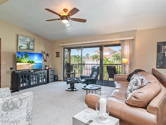 carpeted living room with ceiling fan and lofted ceiling