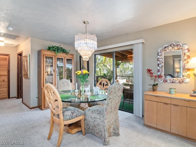 carpeted dining space featuring a notable chandelier