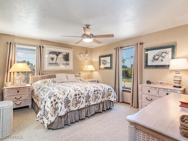 bedroom with light colored carpet and ceiling fan