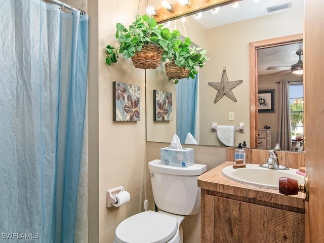 bathroom featuring vanity, ceiling fan, and toilet