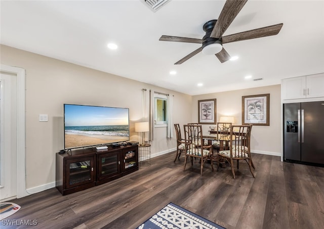 dining space with ceiling fan and dark hardwood / wood-style flooring