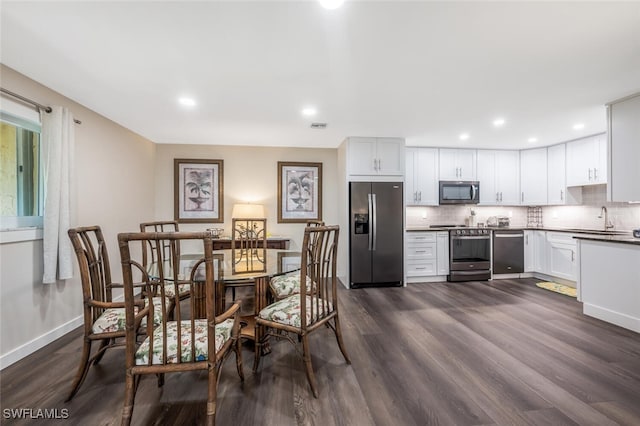 dining area with dark hardwood / wood-style floors and sink