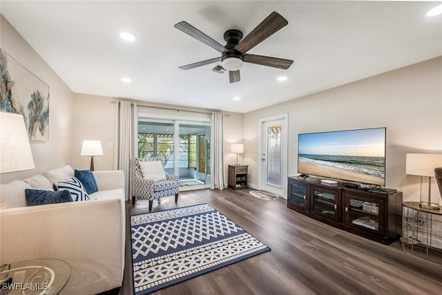 living room featuring dark hardwood / wood-style floors and ceiling fan