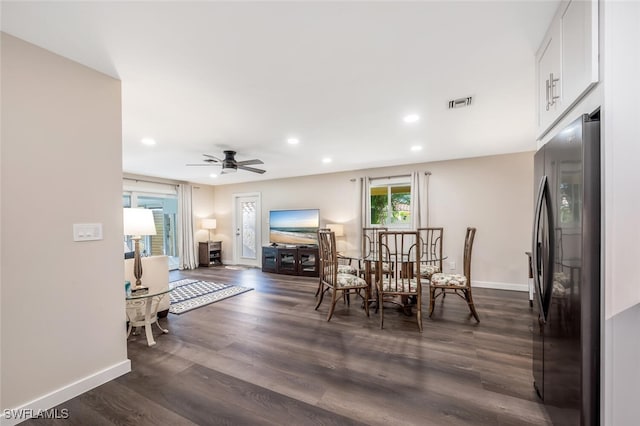 dining area with dark wood-type flooring and ceiling fan