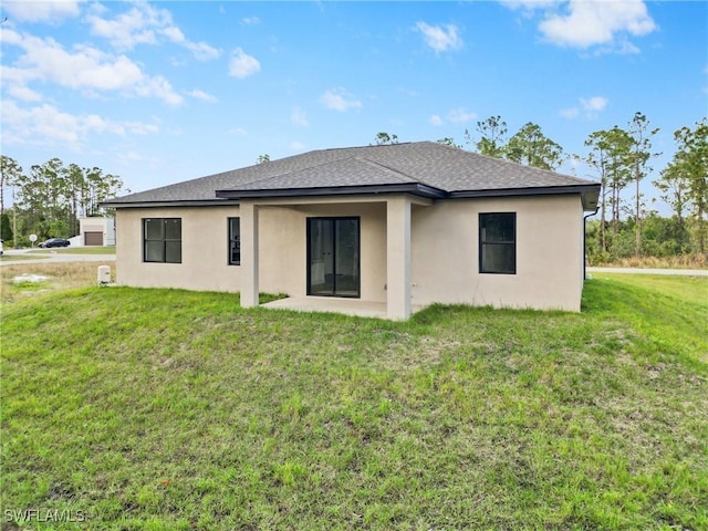 rear view of house with a patio area and a lawn