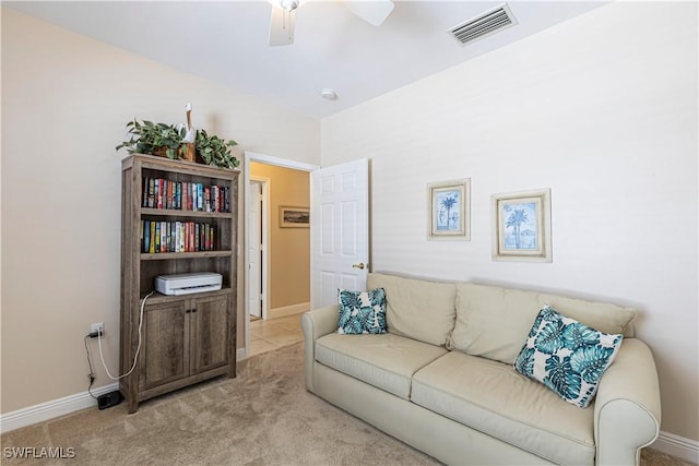 carpeted living room with ceiling fan