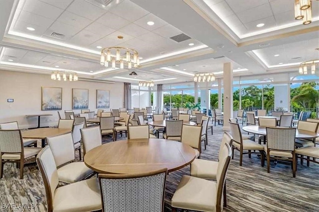 dining space featuring carpet flooring and an inviting chandelier