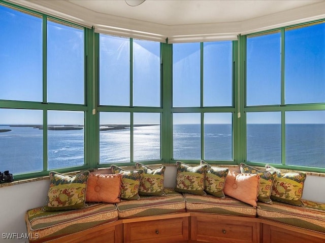 sunroom / solarium featuring a water view