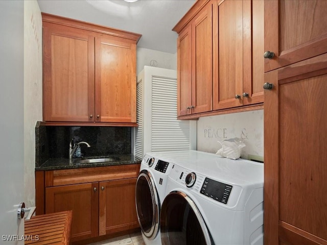 laundry room with sink, cabinets, and independent washer and dryer