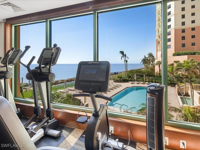 workout area featuring a water view