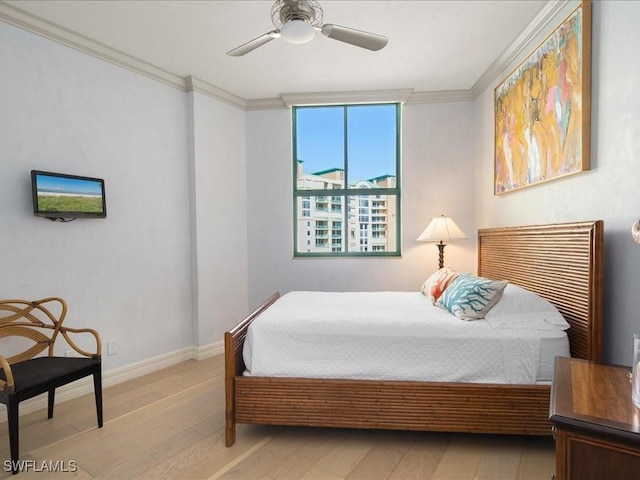 bedroom featuring crown molding, ceiling fan, and light wood-type flooring