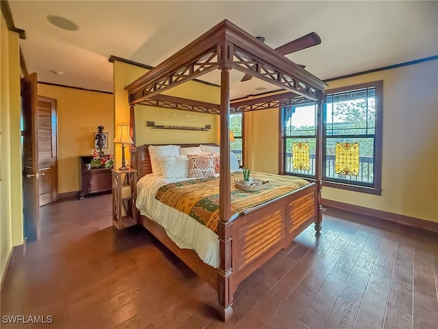 bedroom with crown molding and dark hardwood / wood-style floors