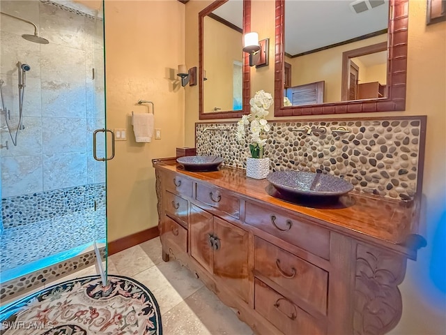 bathroom featuring tasteful backsplash, an enclosed shower, vanity, ornamental molding, and tile patterned floors