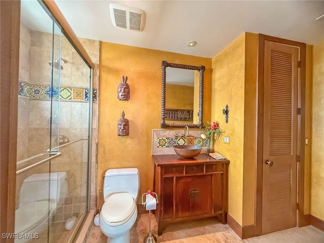 bathroom featuring vanity, toilet, and walk in shower