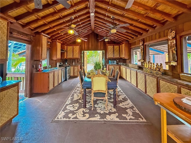 dining area with ceiling fan, wooden ceiling, plenty of natural light, and vaulted ceiling with beams