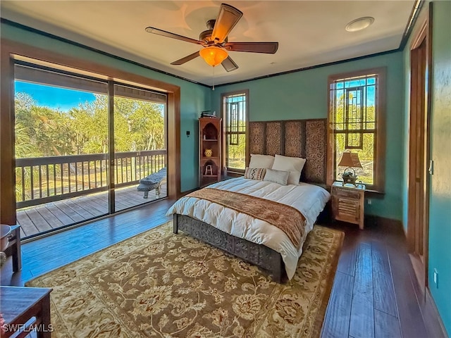 bedroom with access to exterior, dark hardwood / wood-style floors, and ceiling fan