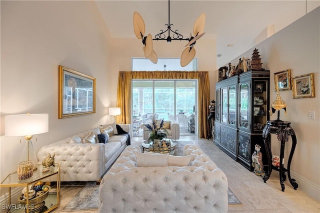 living area with a towering ceiling and baseboards