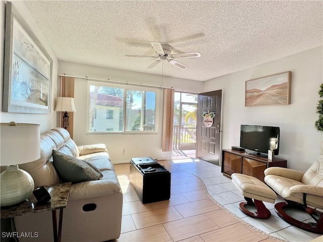 tiled living room featuring a textured ceiling and ceiling fan