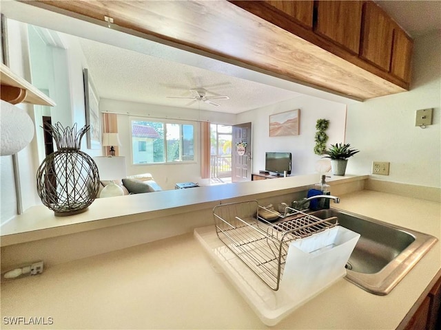 kitchen with ceiling fan and a textured ceiling