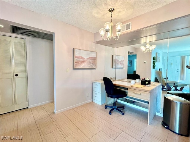 office featuring an inviting chandelier and a textured ceiling