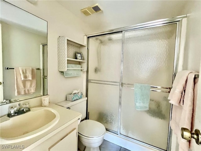 bathroom featuring walk in shower, vanity, and toilet