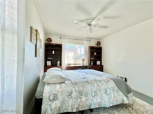 bedroom with a textured ceiling and ceiling fan