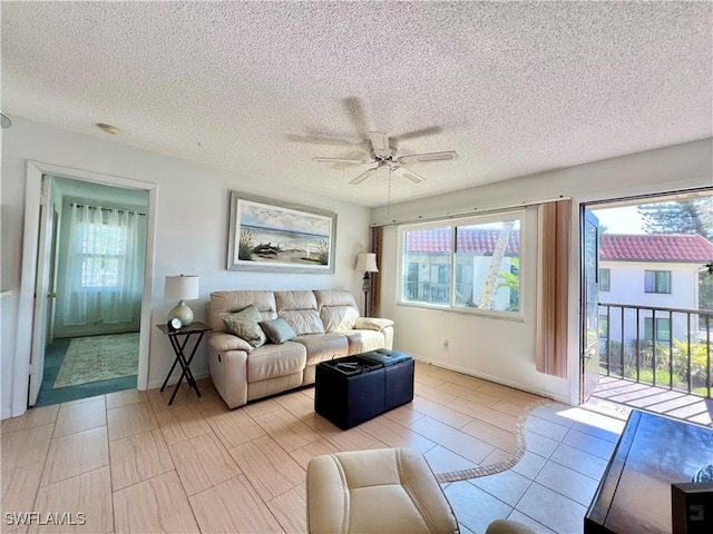 living room with a textured ceiling and ceiling fan