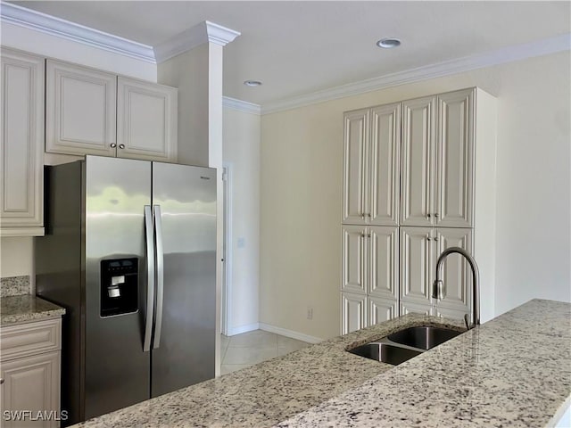 kitchen featuring sink, light stone counters, stainless steel fridge with ice dispenser, light tile patterned floors, and ornamental molding