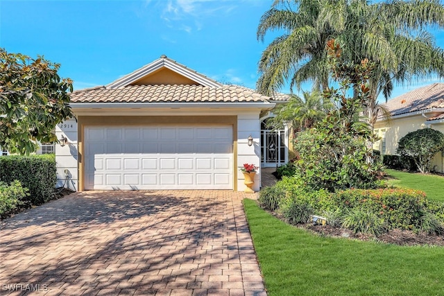 view of front of home with a garage and a front lawn