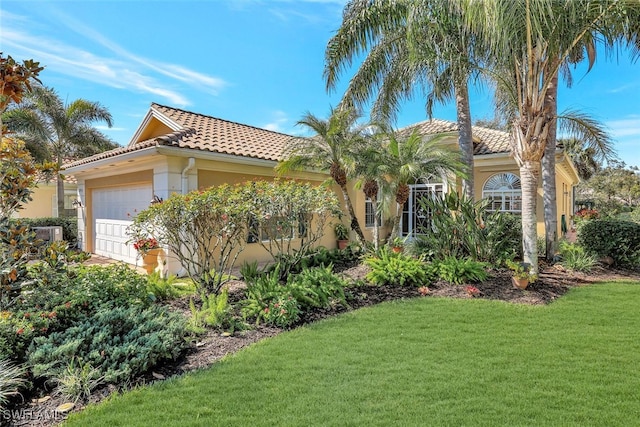 mediterranean / spanish-style home with a garage and a front yard