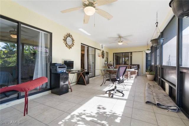 sunroom / solarium featuring ceiling fan