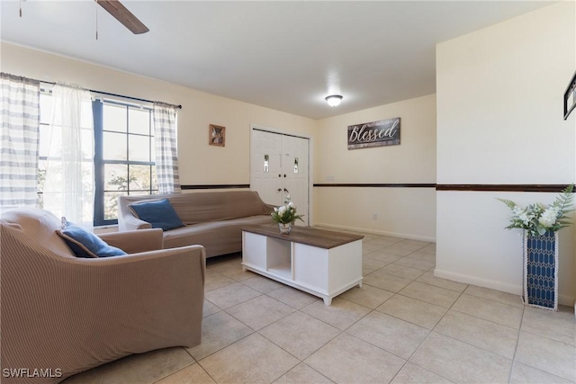 living room with light tile patterned floors and ceiling fan