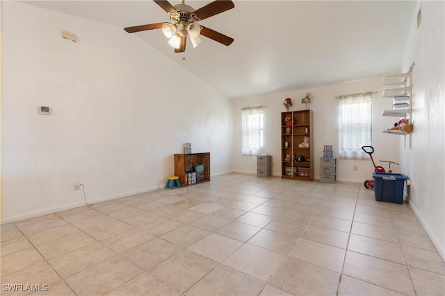 spare room featuring lofted ceiling, light tile patterned floors, and ceiling fan